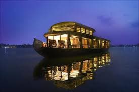Ashtamudi Lake at sunset with traditional fishing boats